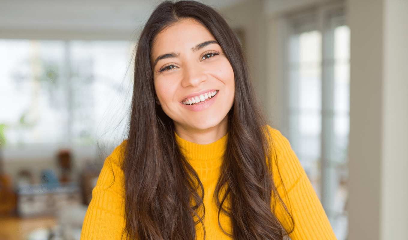 Smiling woman with headphones accessibility page | Advanced Orthodontics in Burien, WA