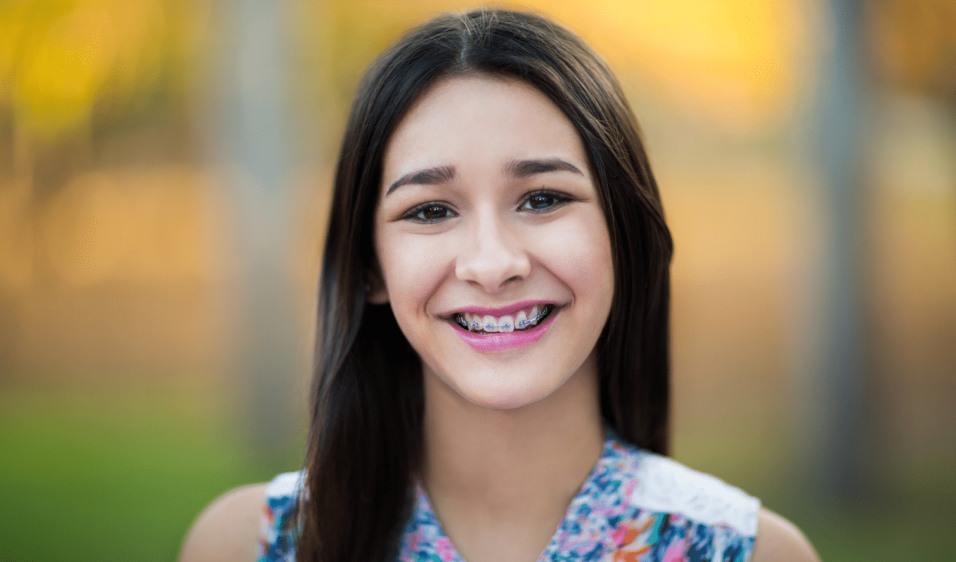 Smiling patient with braces surgical orthodontics page | Advanced Orthodontics in Burien, WA