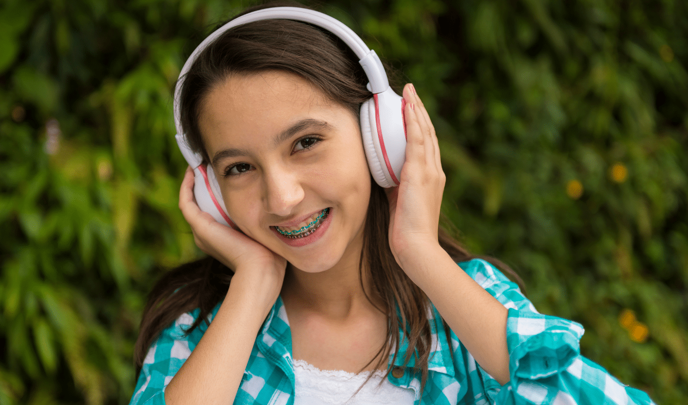 Teen girl with pink headphones doctor page photo | Advanced Orthodontics in Burien, WA