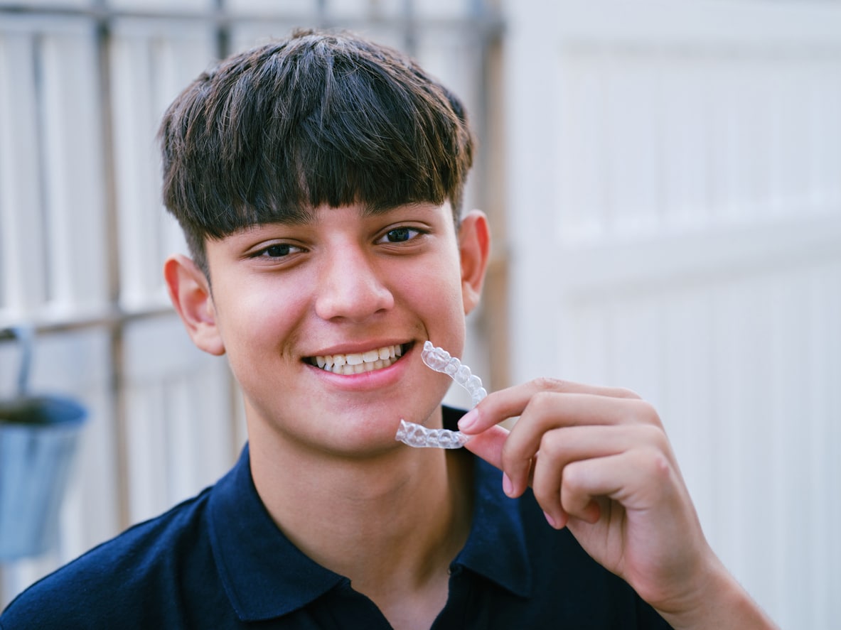 Teen boy smiling with invisible teeth aligner | Advanced Orthodontics in Burien, WA